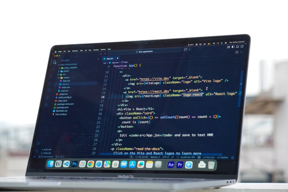 A close-up view of a MacBook Pro laptop on a table outdoors, displaying lines of code in a dark-themed text editor window. The code includes HTML elements such as 'div' and 'img' tags, with color-code